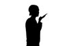 Silhouette Young woman talking on the phone holding it to her fa