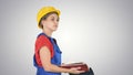 Woman construction worker in hard hat and workwear uniform checking the list on gradient background. Royalty Free Stock Photo