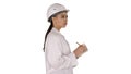 Woman engineer with helmet is holding pen and checklist putting something down while walking on white background. Royalty Free Stock Photo