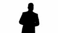 Silhouette Man in suit walking and counting money. Royalty Free Stock Photo