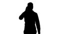 Silhouette Young arab man walking and talking on the phone and smile. Royalty Free Stock Photo