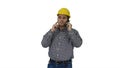 Construction worker using smartphone on white background. Royalty Free Stock Photo