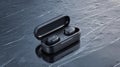 Medium shot of wireless earbuds resting on a sleek surface highlighting their compact design and portability for onthego Royalty Free Stock Photo