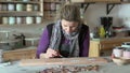 Woman ceramist working on tiles with technique of cuerda seca