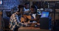 Young musicians playing in home studio Royalty Free Stock Photo