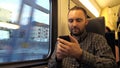 Young man using smartphones in the subway. Royalty Free Stock Photo