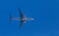 Medium size blue passenger airplane on clear sky background. bottom view a few seconds before landing. composition Royalty Free Stock Photo