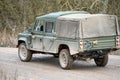 a medium size military utility vehicle driving along a mud track, military exercise Wilts UK