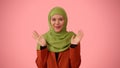 Medium-sized isolated photo capturing an attractive young woman wearing a hijab, veil. She is expressing wow and