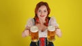 Medium yellow background isolated shot from above of a young German woman, waitress shot from above wearing a