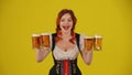 Medium yellow background isolated shot of a young German woman, waitress, wearing a traditional costume, holding four