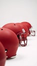 Mediumshot image featuring red American football helmets against a white backdrop Royalty Free Stock Photo
