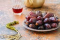 Medjoul - dried dates or kurma in a vintage plate and tea. Royalty Free Stock Photo