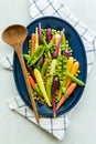 A medley of pea pods, peas and rainbow carrots on an oval plate. Royalty Free Stock Photo