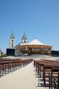 MEDUGORJE, BOSNIA AND HERZEGOVINA - JULY 4, 2016: Benches and altar behind the parish church of St. James, the shrine of Our Lady Royalty Free Stock Photo