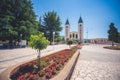 MEDUGORJE, BOSNIA AND HERZEGOVINA - JULY 12, 2019: Virgin Mary statue and the parish church of St. James, the shrine of Our Lady o Royalty Free Stock Photo