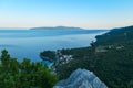 Medveja - A small metal cross on a rock with a panoramic view of the shore Royalty Free Stock Photo