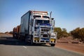 White Kenworth heavy road train truck transporting heavy stuff with  three trailers in Western Australia with motion blur effect Royalty Free Stock Photo