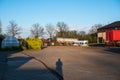 Meerhout, Antwerp Province, Belgium - The main court of a modern farm with barns and agriculture vehicles