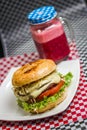 Burger with cheese tomato and a drink Royalty Free Stock Photo