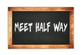 MEET HALF WAY text written on wooden frame school blackboard