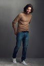 Meet Mr Handsome. Studio shot of a handsome young man posing against a gray background. Royalty Free Stock Photo