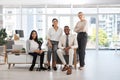 Meet the team. Full length shot of a group of diverse businesspeople gathered in their office.