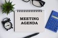 Meeting agenda text on notepad with office concept background. Business concept Royalty Free Stock Photo