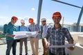 Meeting Of Builders Team Outdoors Group Of Foreman In Hardhat Looking At Plans Duscussing Project With Architect Royalty Free Stock Photo