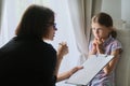 Meeting child girl with school counselor psychotherapist