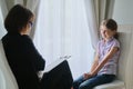 Meeting child girl with school counselor psychotherapist