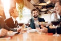 People sit at table eating sushi and drinking wine Royalty Free Stock Photo