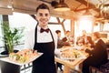 Meeting with chinese businessmen in restaurant. Waiter is posing with sushi. Royalty Free Stock Photo