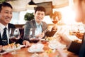 Meeting with chinese businessmen in restaurant. Men are eating sushi. Royalty Free Stock Photo