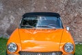 meeting of classic cars. Front closeup on the old orange car