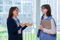 Meeting, conversation of female teacher and girl college student in educational center