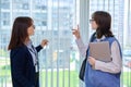 Meeting, conversation of female teacher and girl college student in educational center