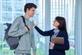 Meeting, conversation of female teacher and guy college student in educational center