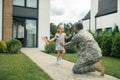 Military servant meeting his cute lovely girl near the house Royalty Free Stock Photo