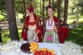 Meeting guest. beautiful girls in national Russian costumes, gowns sundresses with vibrant embroidery - folk group the Wheel.