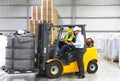 Meeting of the manager and worker in the warehouse - forklift an Royalty Free Stock Photo
