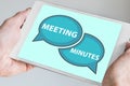 Meeting minutes concept with hands holding modern tablet or smartphone to be used as slide background Royalty Free Stock Photo