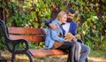 Meeting people with similar interests. Man and woman sit bench park. Read same book together. Couple interested Royalty Free Stock Photo