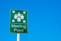 Meeting point green sign against a blue sky Royalty Free Stock Photo