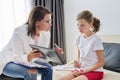 Meeting of pre-teen child girl and female social worker psychologist teacher at office Royalty Free Stock Photo