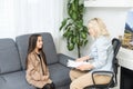 Meeting of pre-teen child girl and female social worker psychologist teacher at office Royalty Free Stock Photo