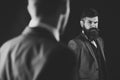 Meeting of reputable businessmen, black background. Man with beard on suspicious face, and shoulders of partner