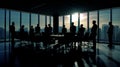 meeting room is abuzz with hushed voices of silhouetted business people in deep conversation