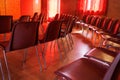 Meeting room with chairs and seats. Event location with red ambiance