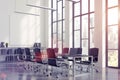 Meeting room interior with a long black table with laptops standing on it and a vertical poster on a white wall. Royalty Free Stock Photo